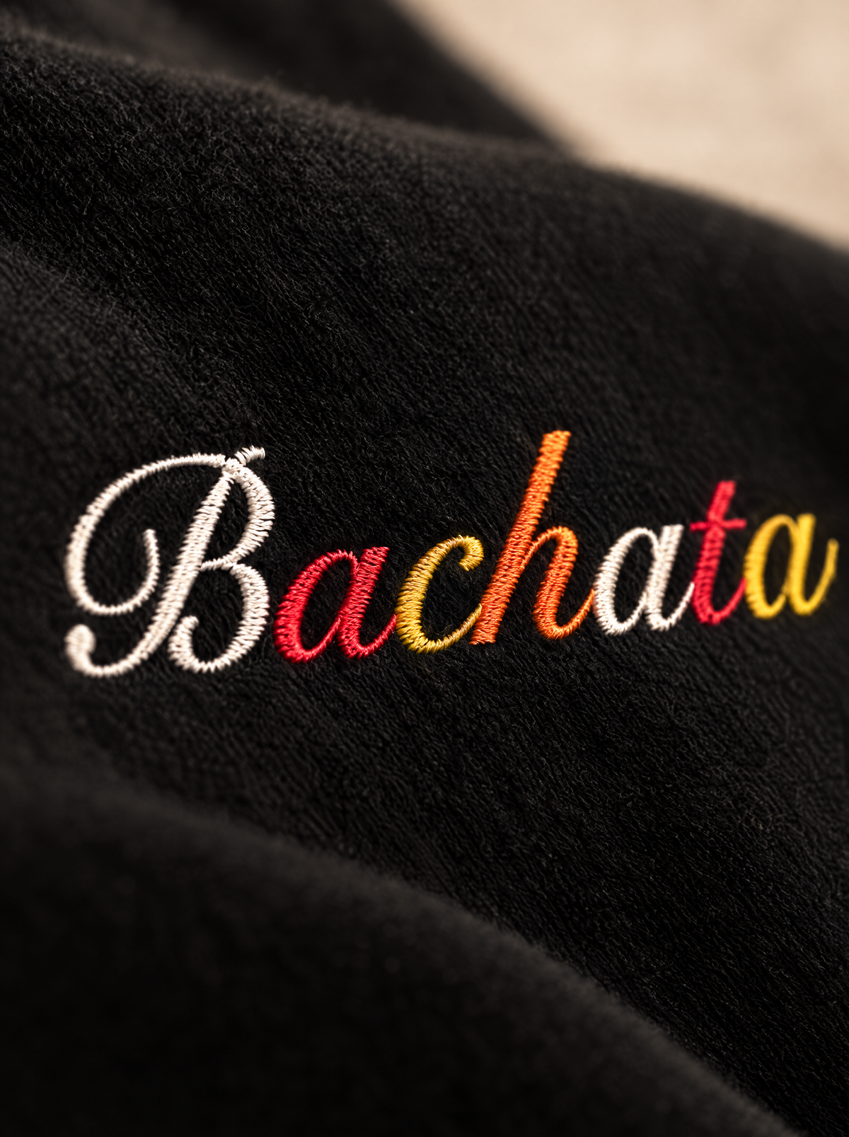 Black — Fabric & print close-up, hand-lettered Bachata script