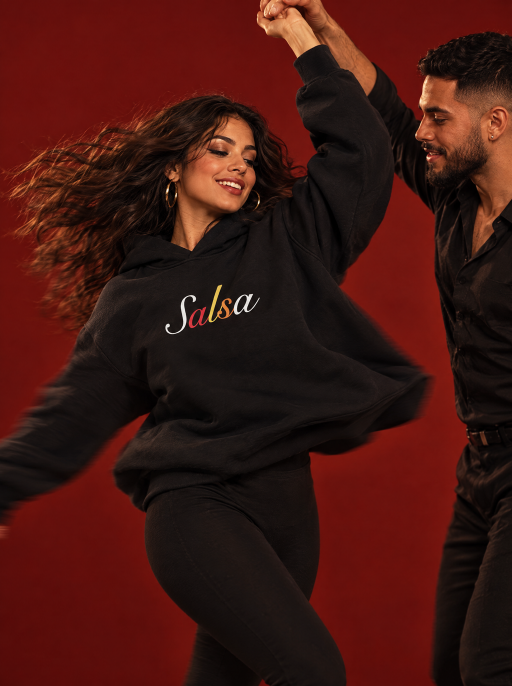 Black — Mari and Leo mid-salsa spin in the Salsa hoodie